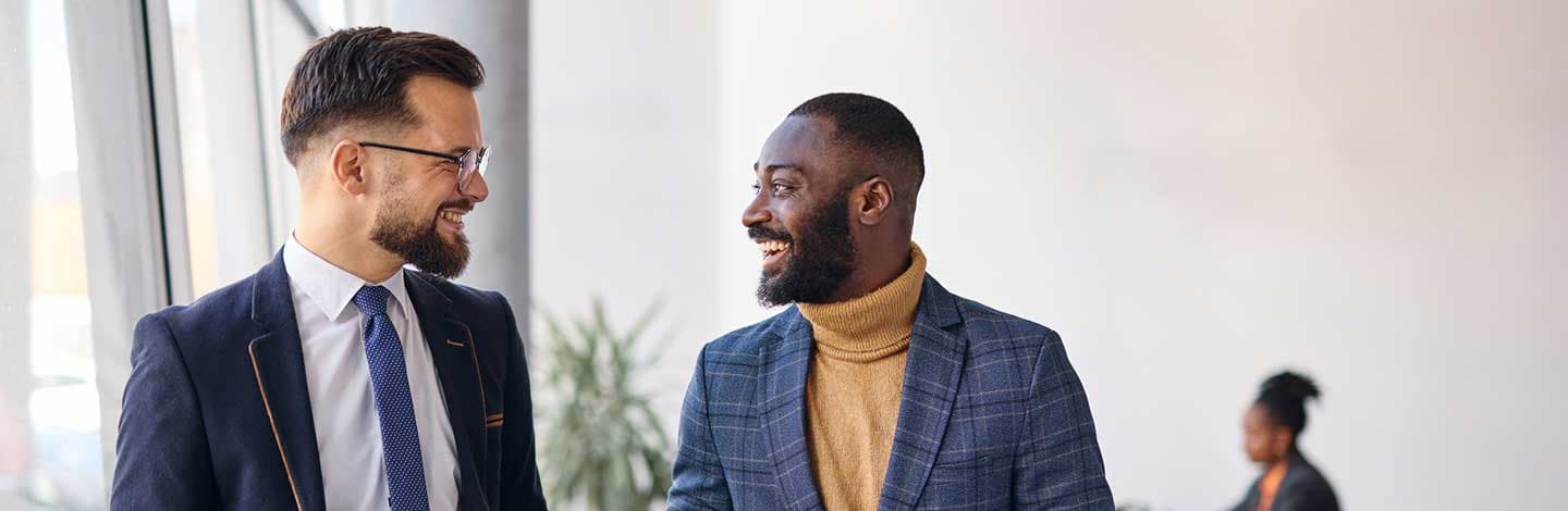 Active allies talking to one another at work