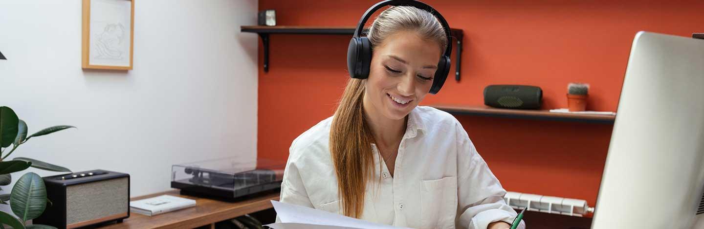 Neurodivergent woman working in home office with headphones on